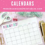 A February 2027 calendar page sits on a pastel desk with scissors, paper clips, a stapler, binder clips, and gold decorative items, under a pink banner that says "free printable 2027 calendars.